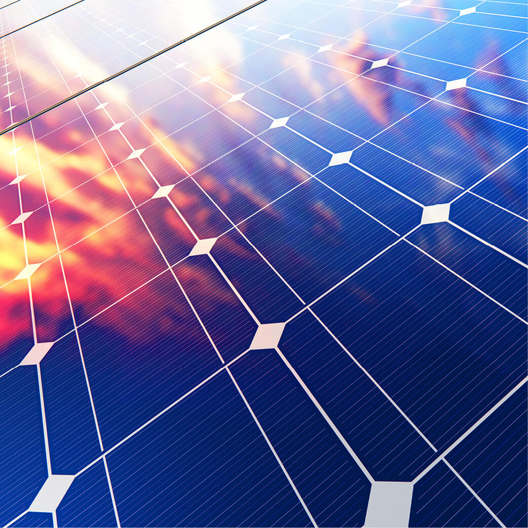 Colourful sky and clouds reflected in solar panels