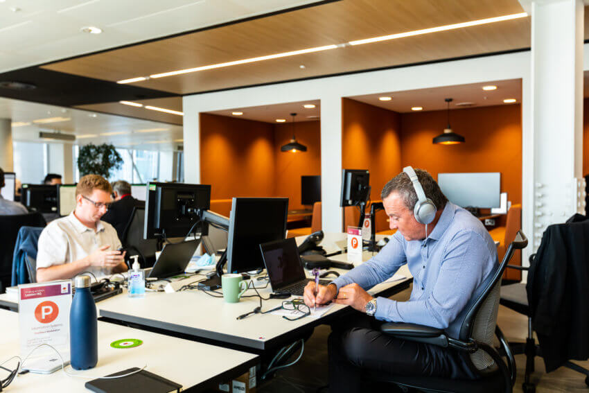 Two Mitie employees working at desks in the Shard offices