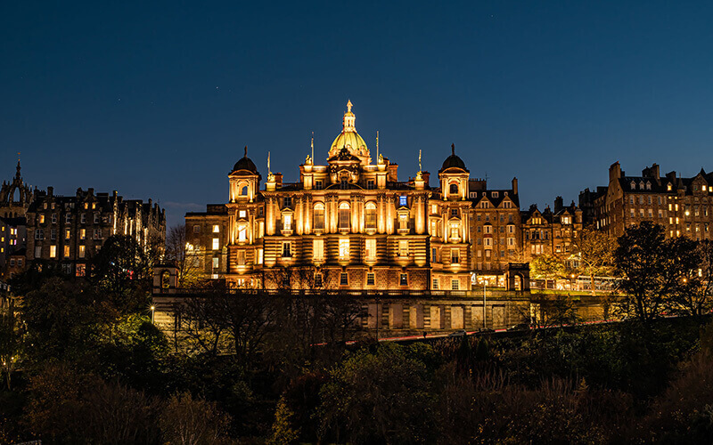 Landscape of a lit up building with warm lighting at night