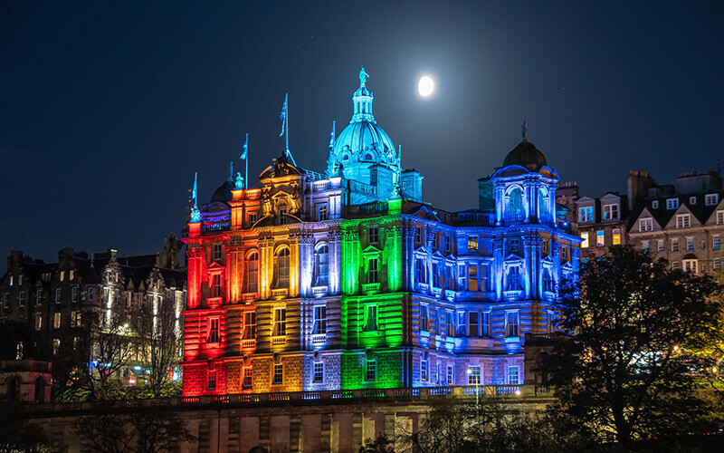 Building at night, lit up by multicoloured lights