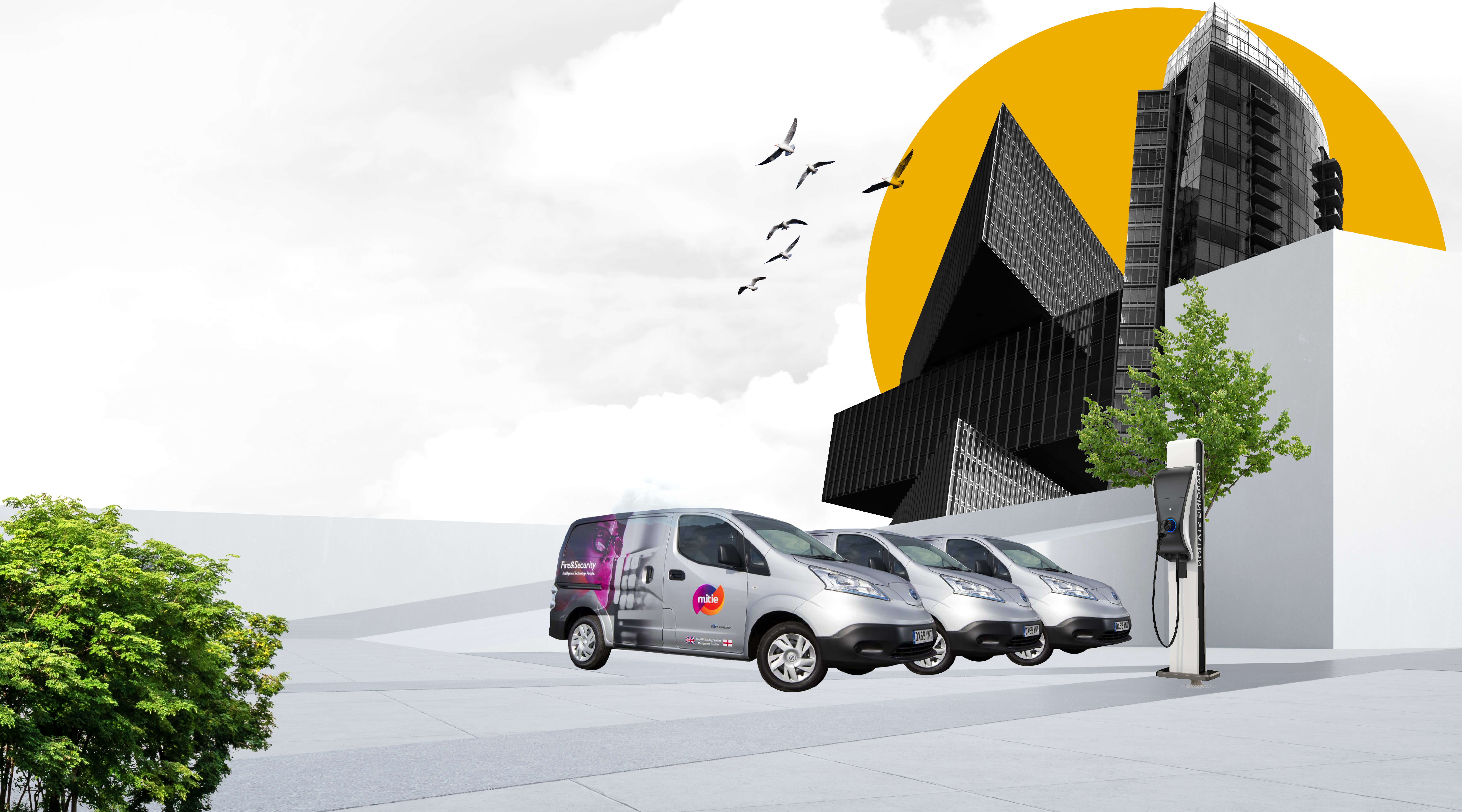 Hero banner of three Mitie EV vans outside an office building, with a yellow sun behind