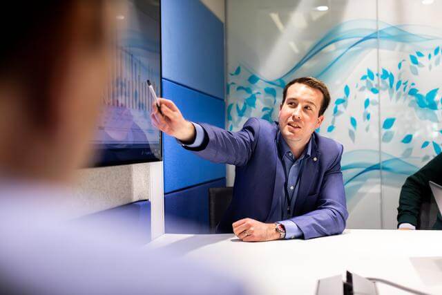 Professional man pointing at a presentation in an office