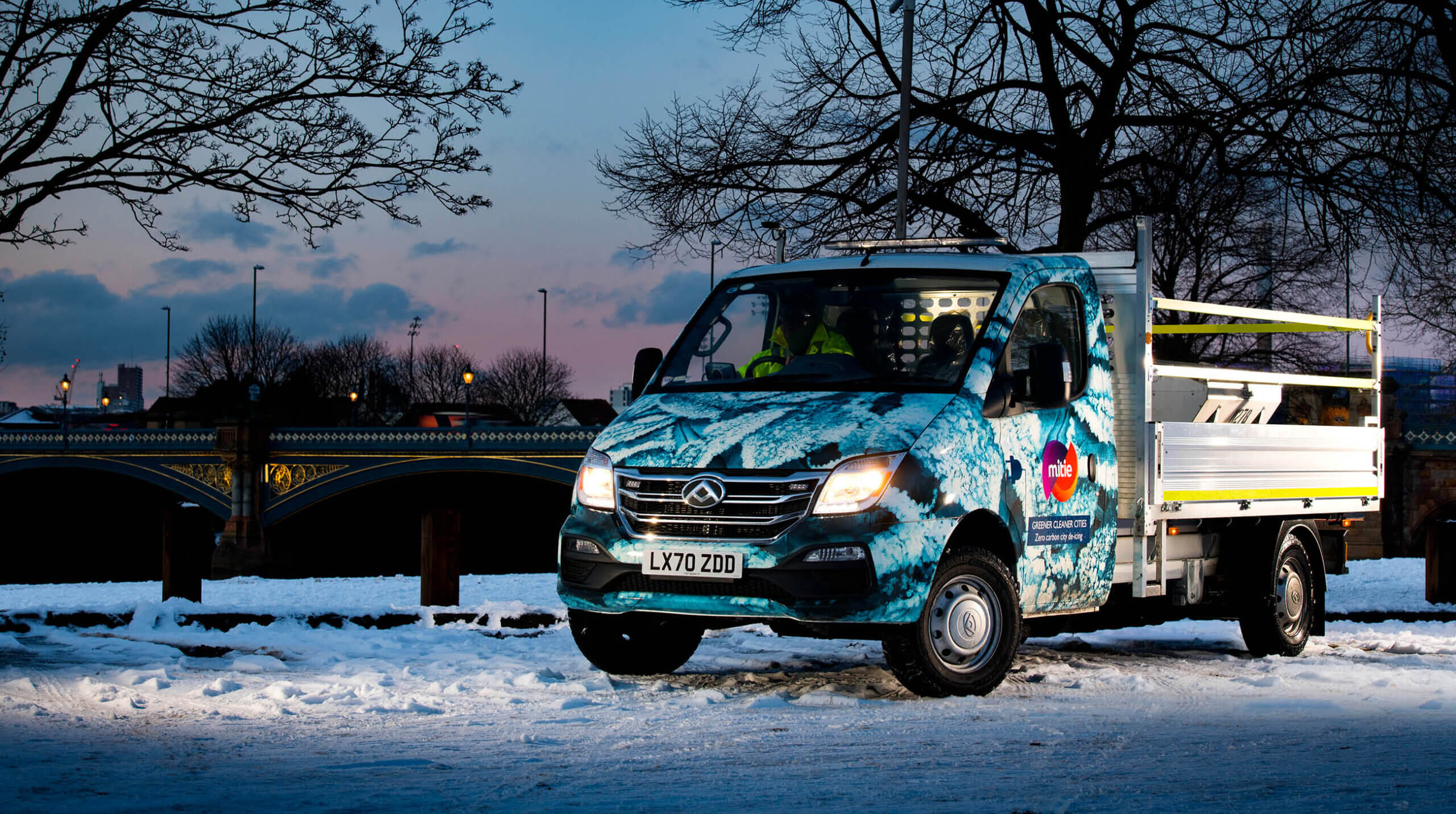 Mitie branded van in a snowy landscape, with the cab decorated with a snowflake pattern